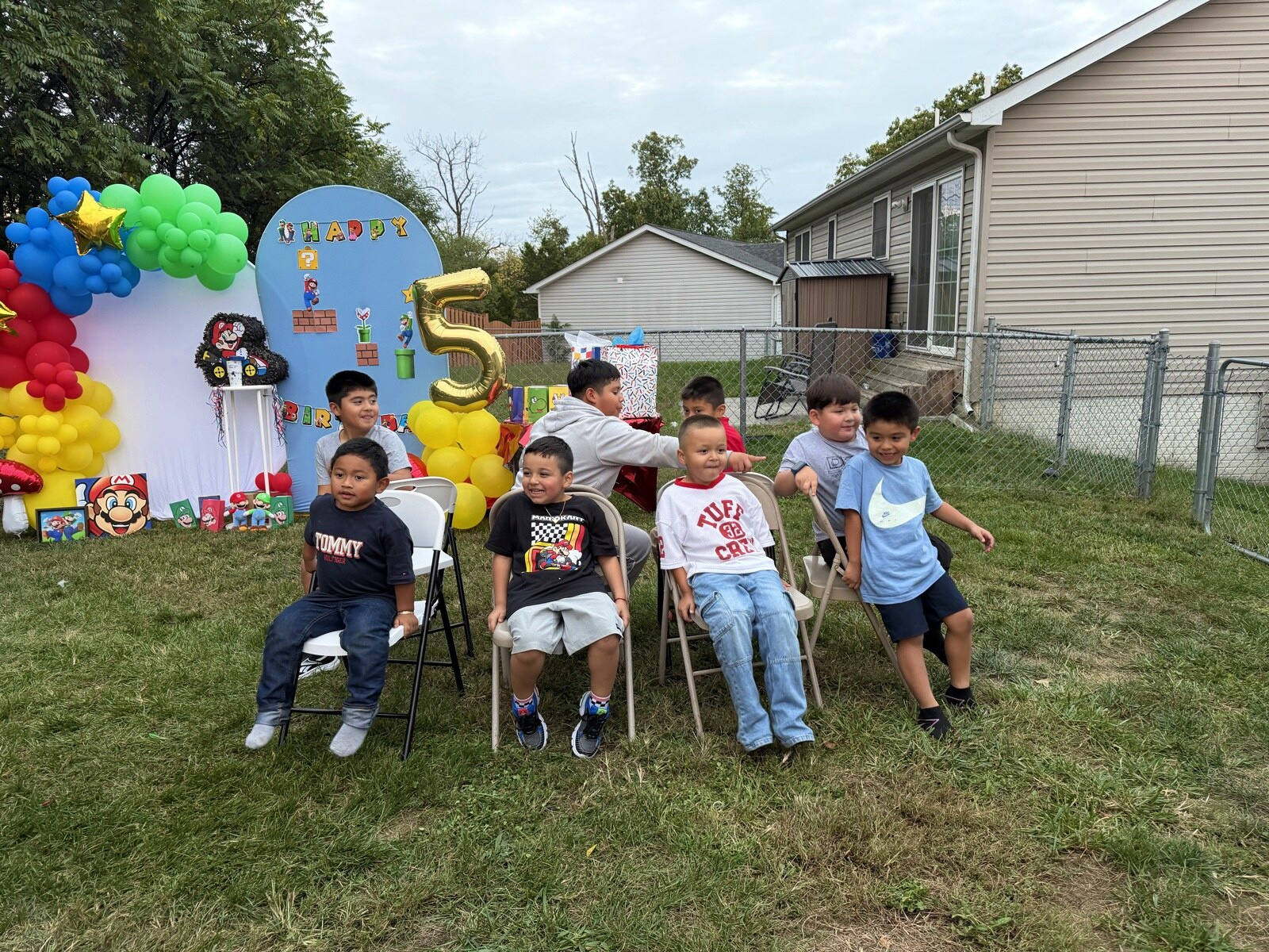 Children smiling while seated at the chair game
